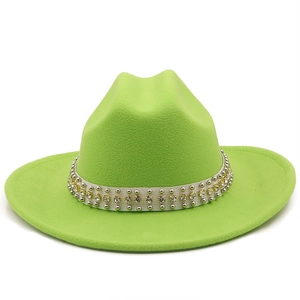Detail of neon green wool fedora hat featuring a studded white band with rhinestones