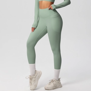 Detail view of sage green high-waisted yoga pants with functional side pocket design