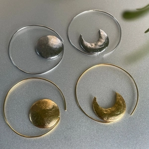 Asymmetric sun and moon hoop earrings with handcrafted hammered texture in gold and silver