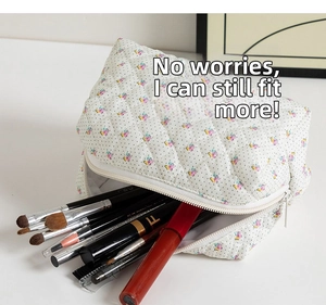 Close-up of quilted floral cosmetic bag showing large capacity for brushes and lipsticks