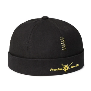 Black cotton docker cap with yellow 'Freedom' embroidery for a vintage street style