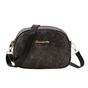 Minimalist oil wax leather crossbody bag in black with adjustable strap and gold hardware