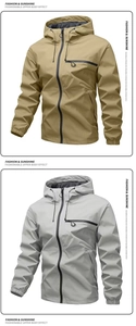Close-up of khaki and light grey windproof jackets with hood and chest zipper pockets