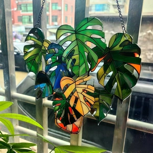 Detailed close-up of layered acrylic lily of the valley window art with metal chain