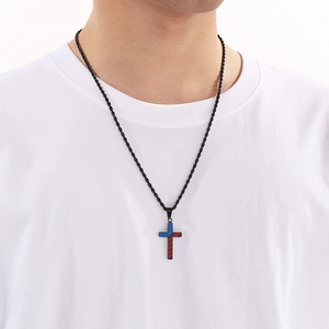 Detail of USA flag cross necklace on a white t-shirt for daily style and outfits