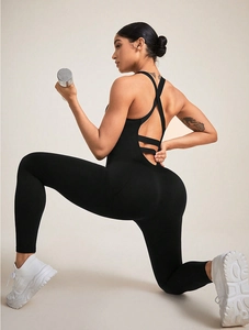 Detail of black seamless yoga unitard showing cross-back straps and hollow out design