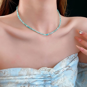 Detail of elegant sky blue amazonite beaded necklace worn on a collarbone