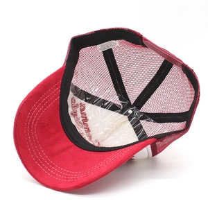 Detail view of cotton-polyester trucker hat interior with breathable mesh and wash label
