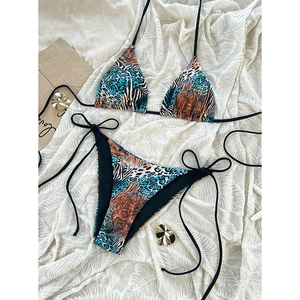 Flat lay of mixed animal print bikini set with leopard and zebra textures on white background