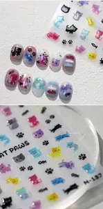 Detailed view of 3D embossed cat and paw print nail art stickers with relief texture