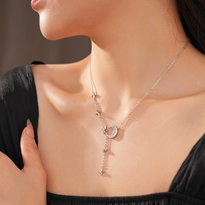 Close-up of zircon crescent moon and star pendant necklace on a female neck