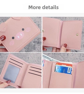 Detail view of pink pig-shaped tri-fold wallet with card slots and litchi texture