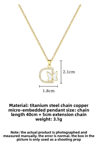 Detailed view of D-letter butterfly pendant with dimensions 2.1x1.8cm in gold finish