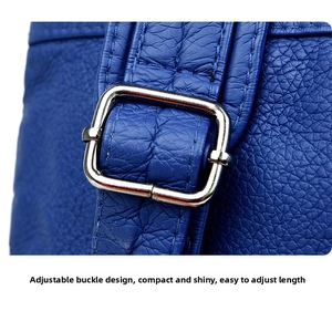 Detail of adjustable silver buckle on premium blue litchi grain leather backpack strap