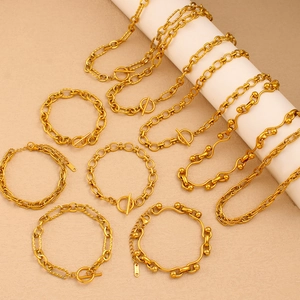 Macro shot of gold-plated titanium jewelry set including necklaces and OT buckle chains