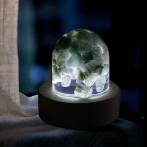 Luminous crystal dome night light with green fluorite stones and warm wooden base