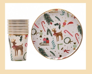 Detail of Christmas tableware set with gold-rimmed reindeer and Santa Claus patterns