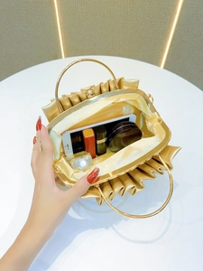 Top view of gold pleated evening clutch showing interior space for phone and makeup