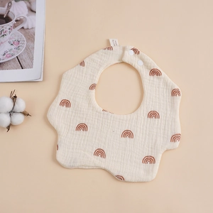 Detail of 6-layer muslin cotton baby bib with brown rainbow prints and snap buttons