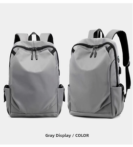 Detailed view of gray business laptop backpack featuring a built-in USB charging port