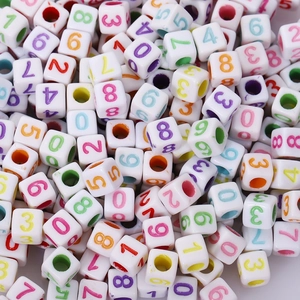 Macro shot of assorted square acrylic beads with colorful numbers for DIY jewelry making