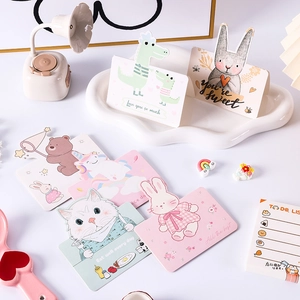 Detail of cute paper greeting cards with dinosaur, rabbit, and bear cartoon patterns