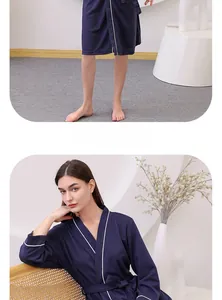 Detailed view of dark blue waffle weave bathrobe with white contrast piping and tie waist