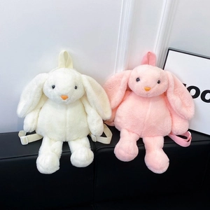 Detail showing plush rabbit backpacks in cream and pink with adjustable nylon straps