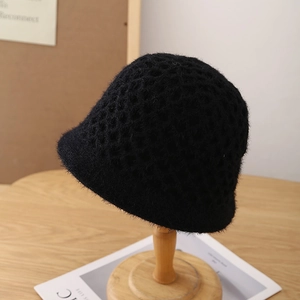 Close-up of black crochet knit bucket hat showing fuzzy mink velvet texture and hollow weave