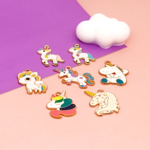 Detail of colorful enamel unicorn charms for DIY jewelry making with gold-tone alloy finish