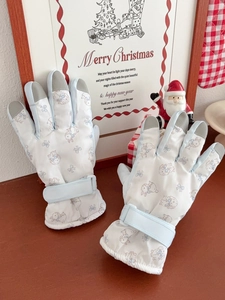 Detail of waterproof ski gloves with rabbit print, touch screen tips and wrist strap