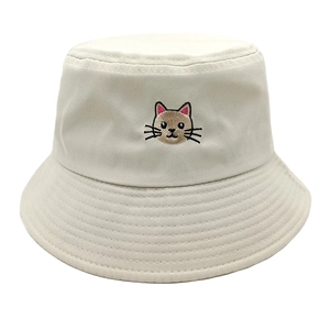 Close-up of cute cat embroidery on a beige cotton canvas bucket hat with clean stitching