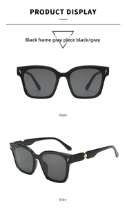 Detail view of black square sunglasses featuring gold lightning accents and gray lenses
