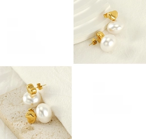 Close-up of heart-shaped gold plated earrings with pearls on a minimalist display stand