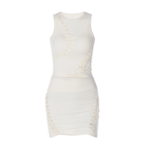 Ensemble deux pièces en tricot blanc avec haut sans manches et minijupe à ajourages
