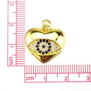Detail of a golden heart pendant with evil eye design and blue zircon stones, measuring 2cm