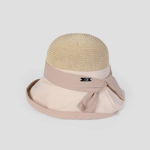 Detail shot of an elegant beige woven summer sun hat for women featuring a bow.