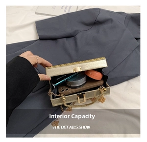 Detail view of gold evening bag interior showing capacity for phone and makeup items