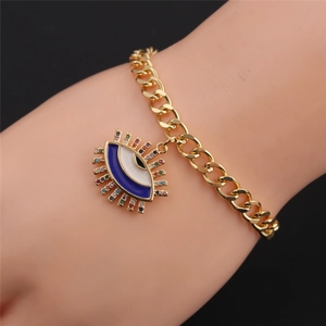 Detail of gold evil eye bracelet with colorful zircons and blue enamel charm for kids