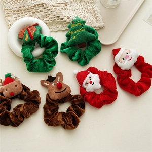Close-up of 6 plush Christmas scrunchies with Santa, reindeer, and tree designs