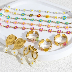 Detailed set of colorful daisy enamel charms on gold stainless steel bracelets and rings