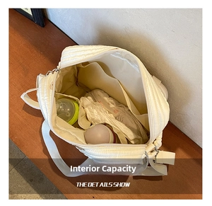 Detail showing the spacious interior of the quilted diaper bag with bottle compartments