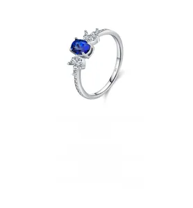 Macro shot of S925 silver ring featuring blue oval gemstone and white marquise accents