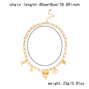 Detailed view of golden chain necklace with shell, bow, and heart charms, 48cm length