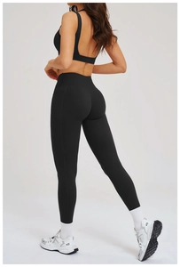Dettaglio dei leggings da yoga neri a vita alta con tasche laterali e design push-up