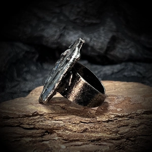 Macro detail of raw blue crystal stone ring with vintage oxidized silver rock texture