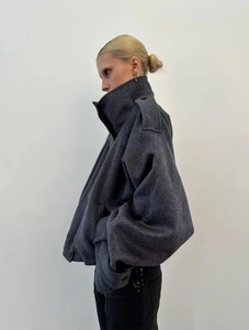 Side view of dark gray loose wool coat with high collar and dropped shoulders for women