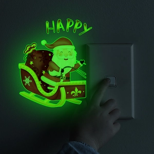 Luminous Santa Claus on sleigh wall sticker glowing in dark near a light switch