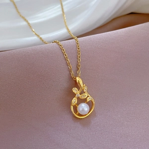 Luxurious gold-tone leaf pendant necklace with pearl and sparkling zircon details