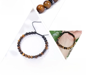 Morse code bracelet with tiger eye stones and black beads featuring an adjustable rope